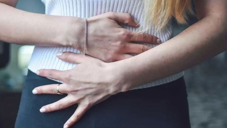 woman holding her stomach