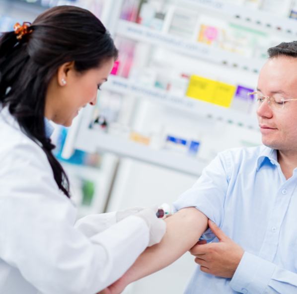 phlebotomist drawing blood from arm 