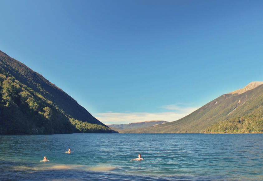 people swimming in lake